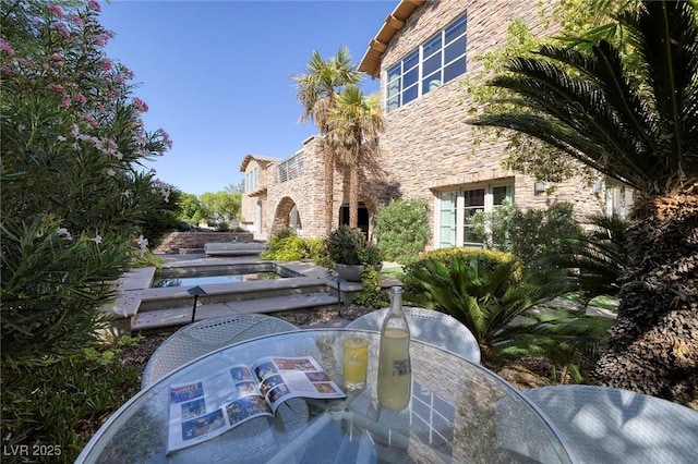 view of home's community featuring a patio and outdoor dining space