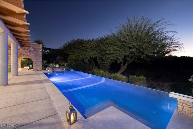 view of pool with an infinity pool