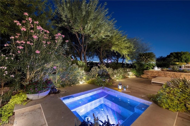 view of pool with a patio and an in ground hot tub