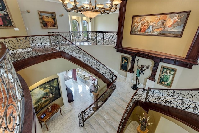 staircase with an inviting chandelier