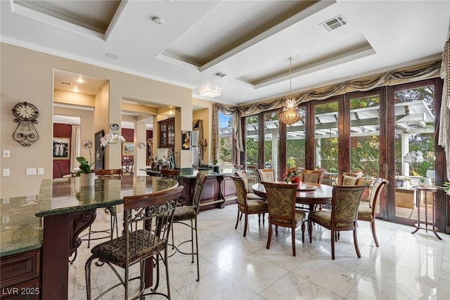 dining space with ornamental molding and a tray ceiling