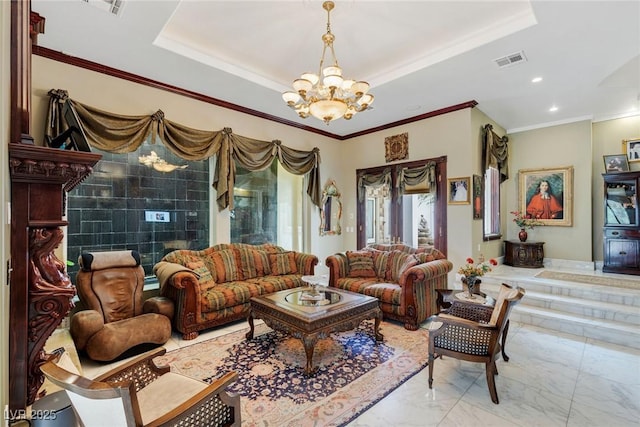 living room with a tray ceiling, ornamental molding, and a chandelier