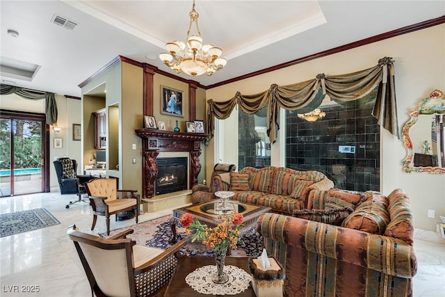 living room with an inviting chandelier, crown molding, and a raised ceiling