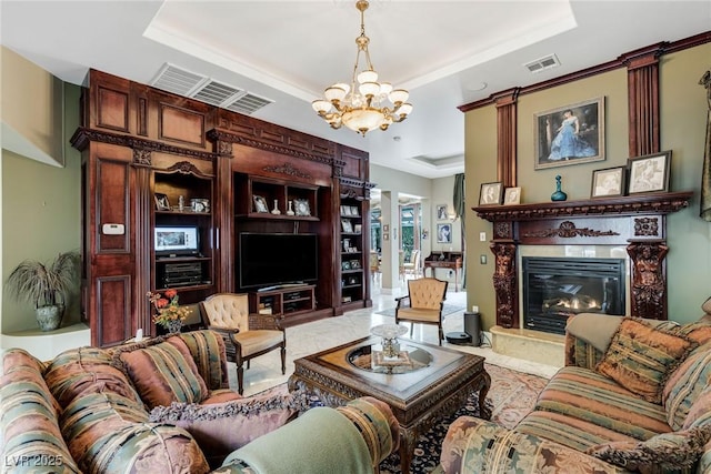 living room featuring a notable chandelier and a raised ceiling