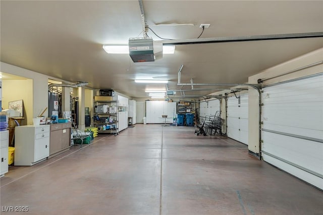 garage with a garage door opener, fridge, and water heater