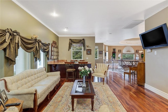 living room featuring ornamental molding and dark hardwood / wood-style floors