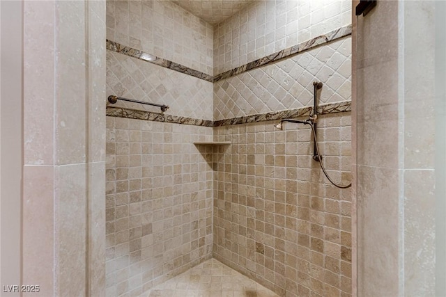 bathroom with tiled shower