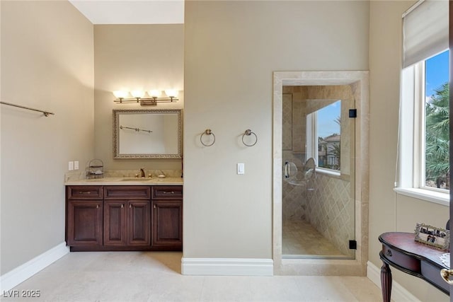 bathroom with an enclosed shower, vanity, and tile patterned floors