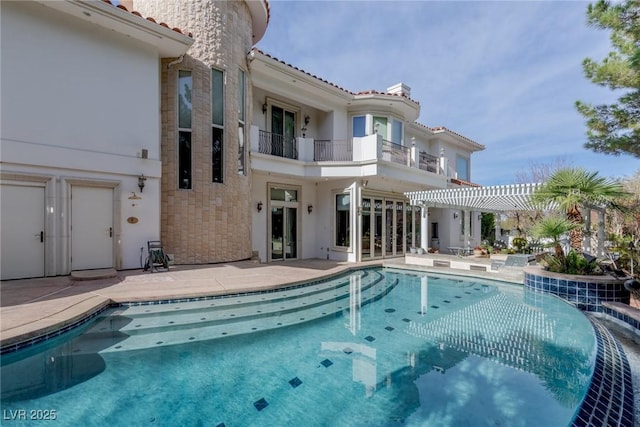 rear view of property with a pergola and a patio