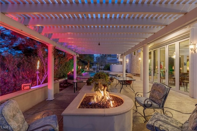 view of patio with a pergola and a fire pit