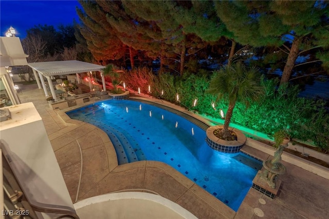 pool at twilight with exterior kitchen and a pergola