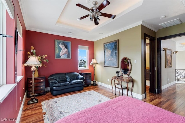 interior space featuring dark hardwood / wood-style flooring, a tray ceiling, ornamental molding, and ceiling fan