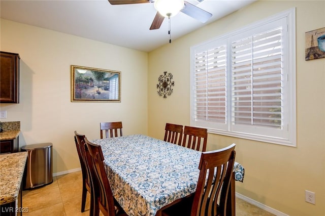 tiled dining area with ceiling fan