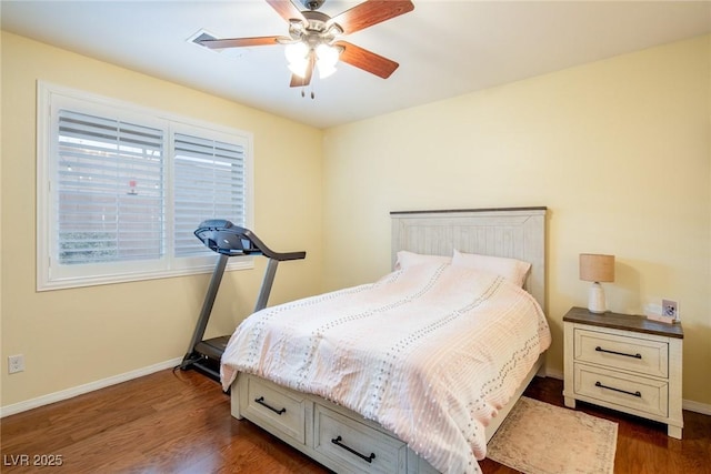 bedroom with ceiling fan and dark hardwood / wood-style flooring