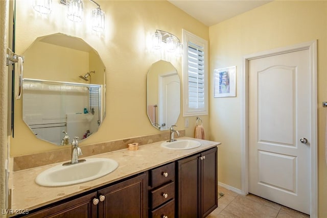 bathroom featuring an enclosed shower, vanity, and tile patterned floors