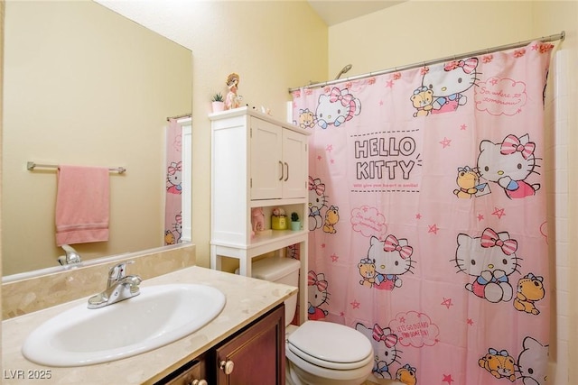 bathroom featuring vanity, toilet, and walk in shower