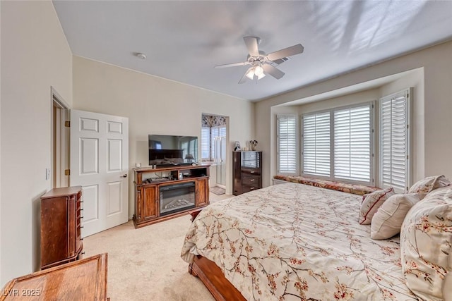 bedroom with ceiling fan and light colored carpet