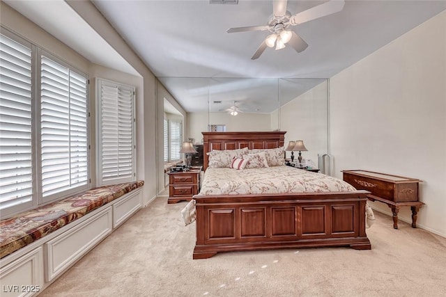 bedroom featuring ceiling fan and light carpet