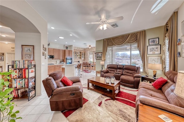 living room with ceiling fan and light tile patterned floors