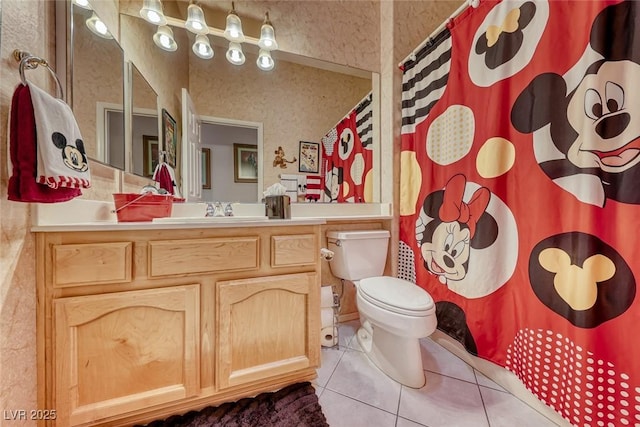 bathroom featuring vanity, toilet, and tile patterned flooring