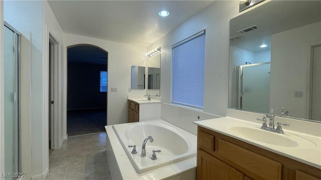 bathroom featuring vanity, tile patterned floors, and plus walk in shower