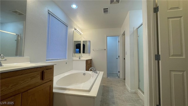 bathroom featuring vanity, tile patterned flooring, and plus walk in shower