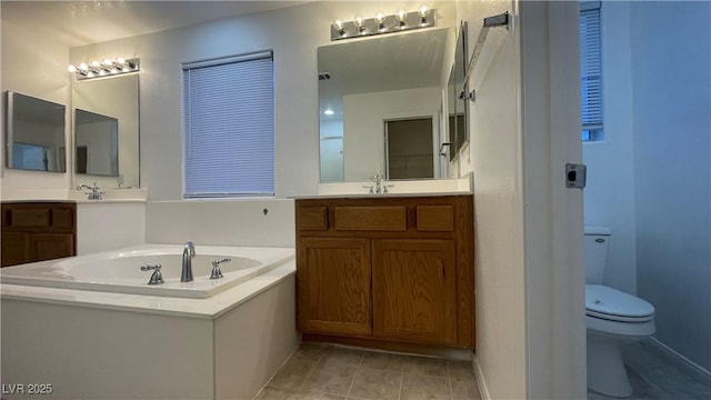 bathroom with vanity, a bathing tub, and toilet