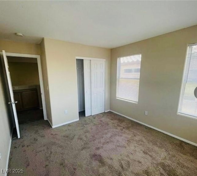 unfurnished bedroom featuring a closet and carpet flooring