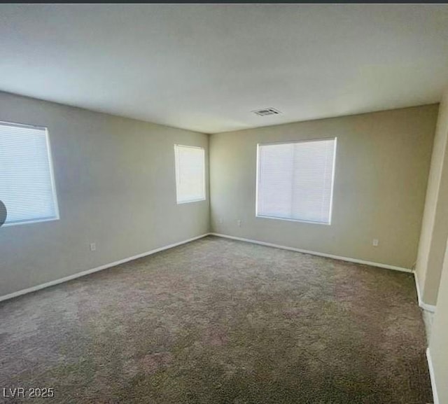 empty room featuring dark colored carpet