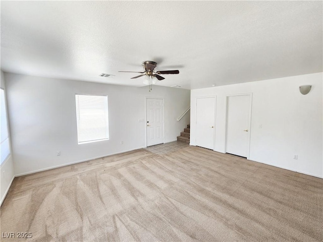 interior space with ceiling fan