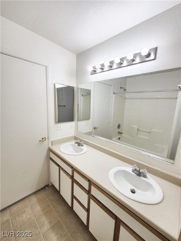 bathroom featuring tile patterned floors, bathtub / shower combination, and vanity