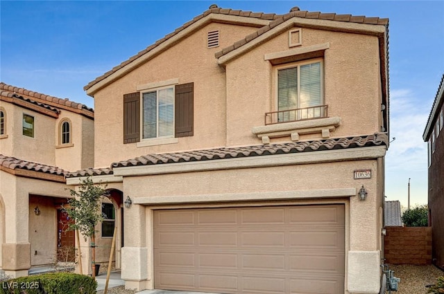 mediterranean / spanish house with a garage