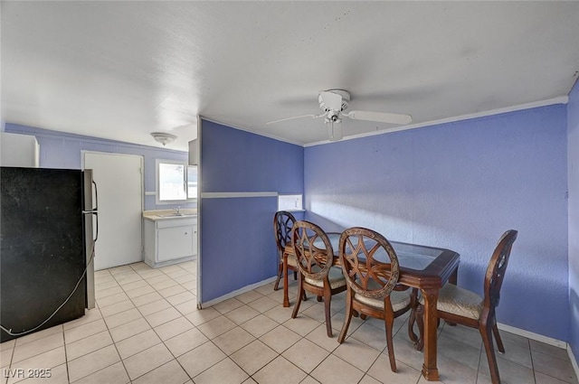 dining room featuring crown molding, sink, light tile patterned floors, and ceiling fan