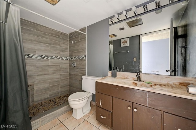 bathroom with vanity, curtained shower, tile patterned floors, and toilet