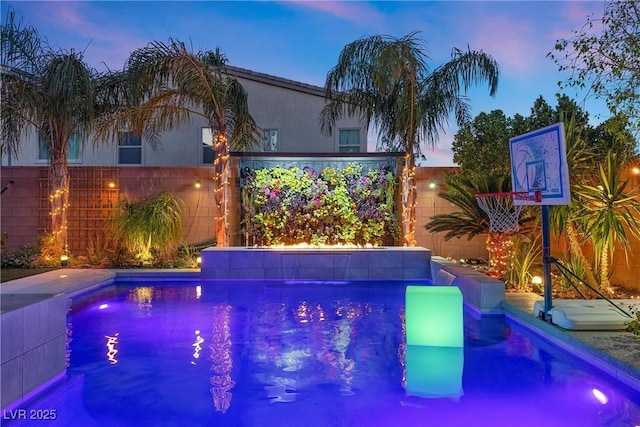 view of pool at dusk