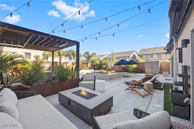 view of patio / terrace featuring an outdoor living space with a fire pit