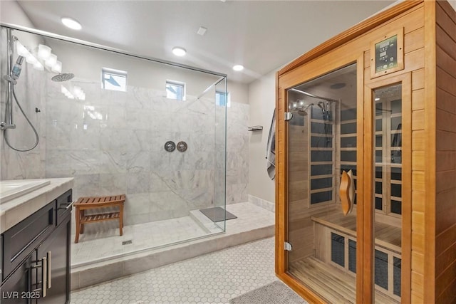 bathroom with vanity, tile patterned flooring, and a tile shower