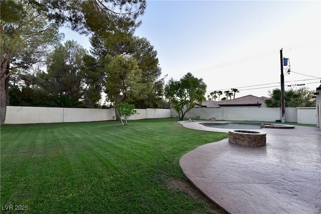 view of yard featuring a patio and an outdoor fire pit