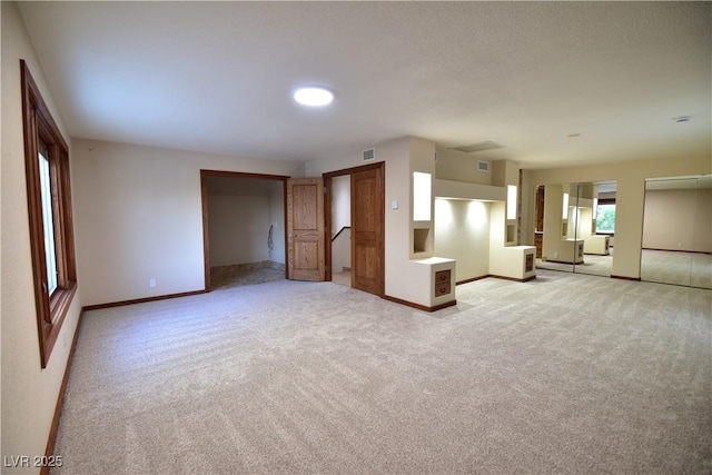 unfurnished living room with light carpet