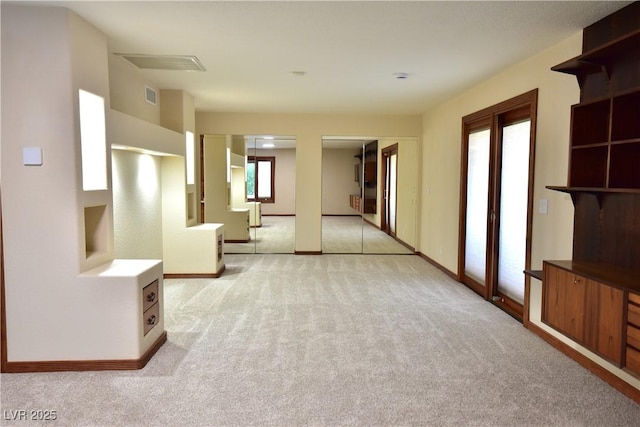 unfurnished living room with light carpet