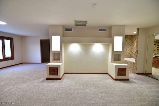 unfurnished living room with light colored carpet