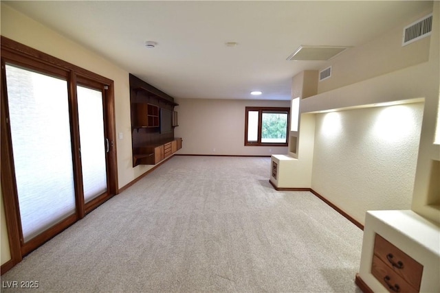 unfurnished living room featuring light colored carpet