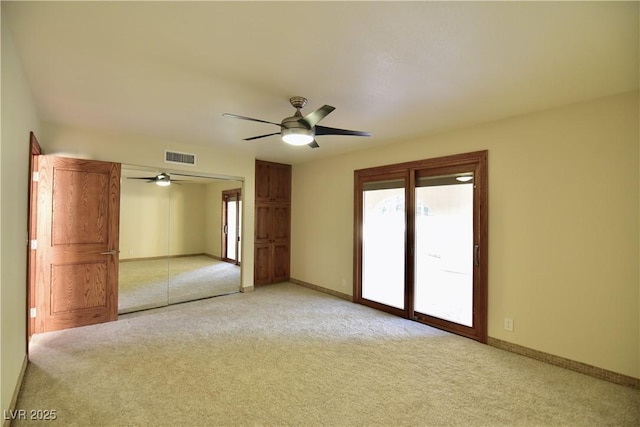 carpeted empty room with ceiling fan