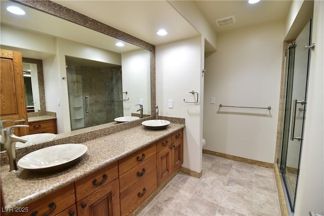 bathroom featuring vanity, toilet, and walk in shower