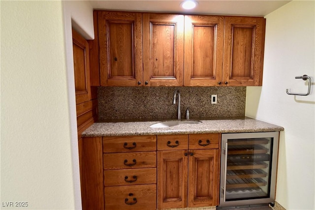 kitchen featuring sink, beverage cooler, and backsplash