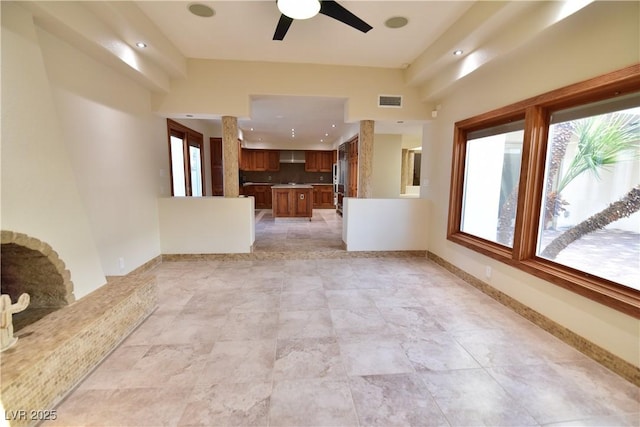 unfurnished living room featuring ceiling fan