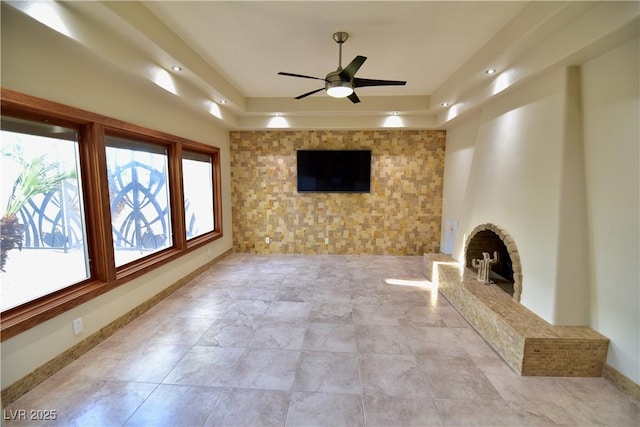 unfurnished living room with ceiling fan