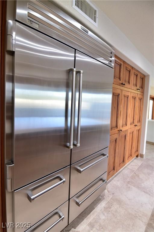 kitchen featuring light tile patterned floors and built in refrigerator