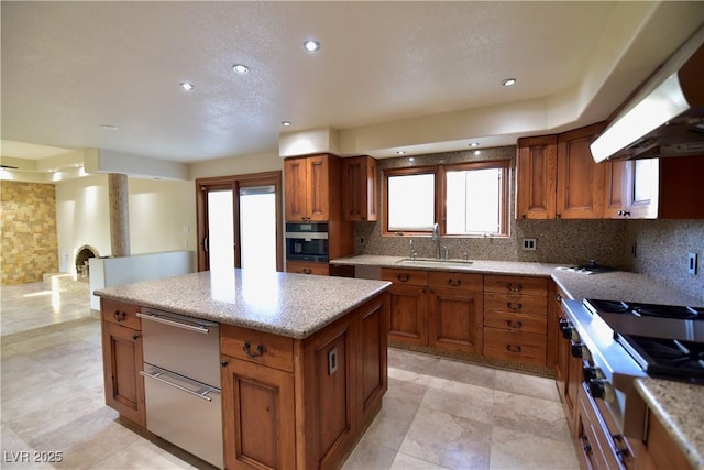 kitchen featuring sink, decorative backsplash, exhaust hood, and a center island