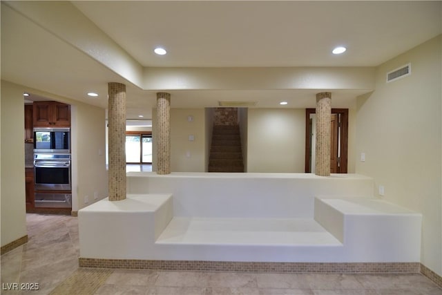 bathroom featuring ornate columns and tile patterned flooring